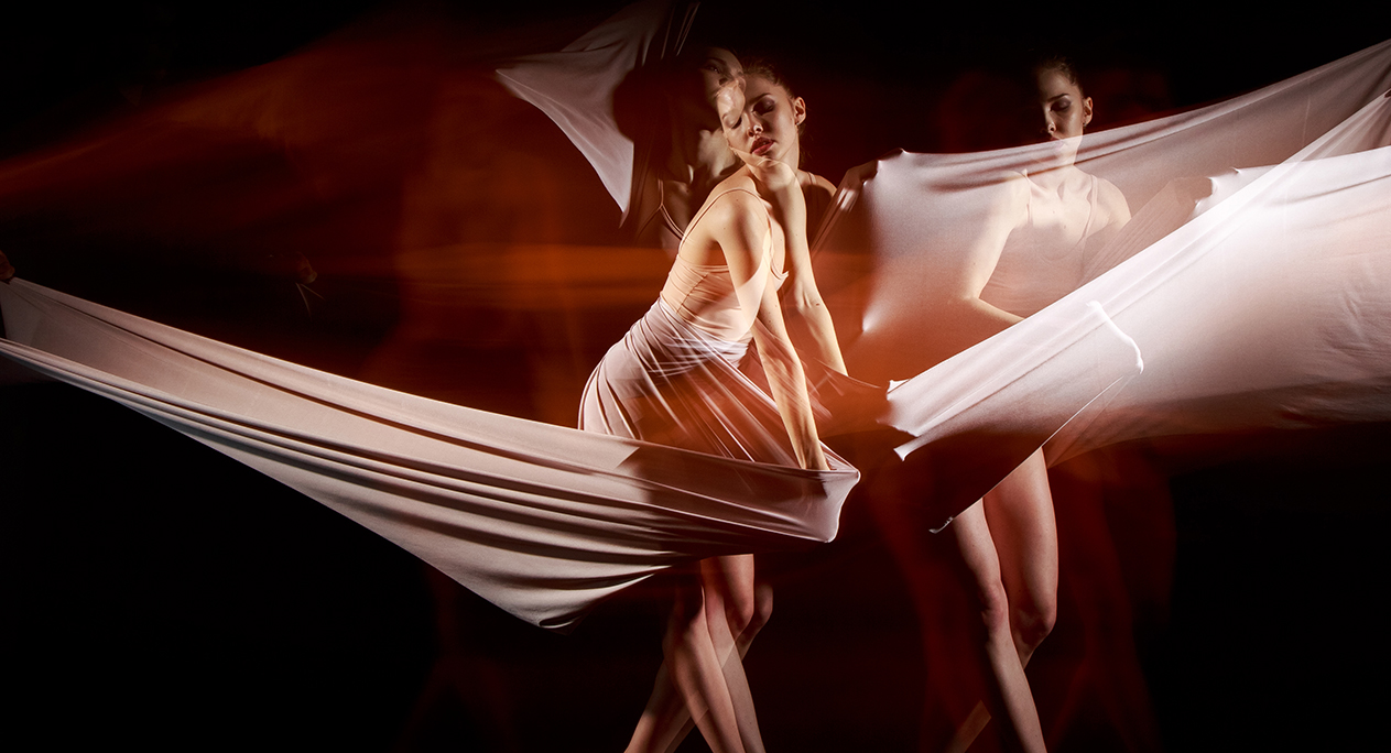 The sensual and emotional dance of beautiful ballerina with hammock fabric . Photography technique with strobe